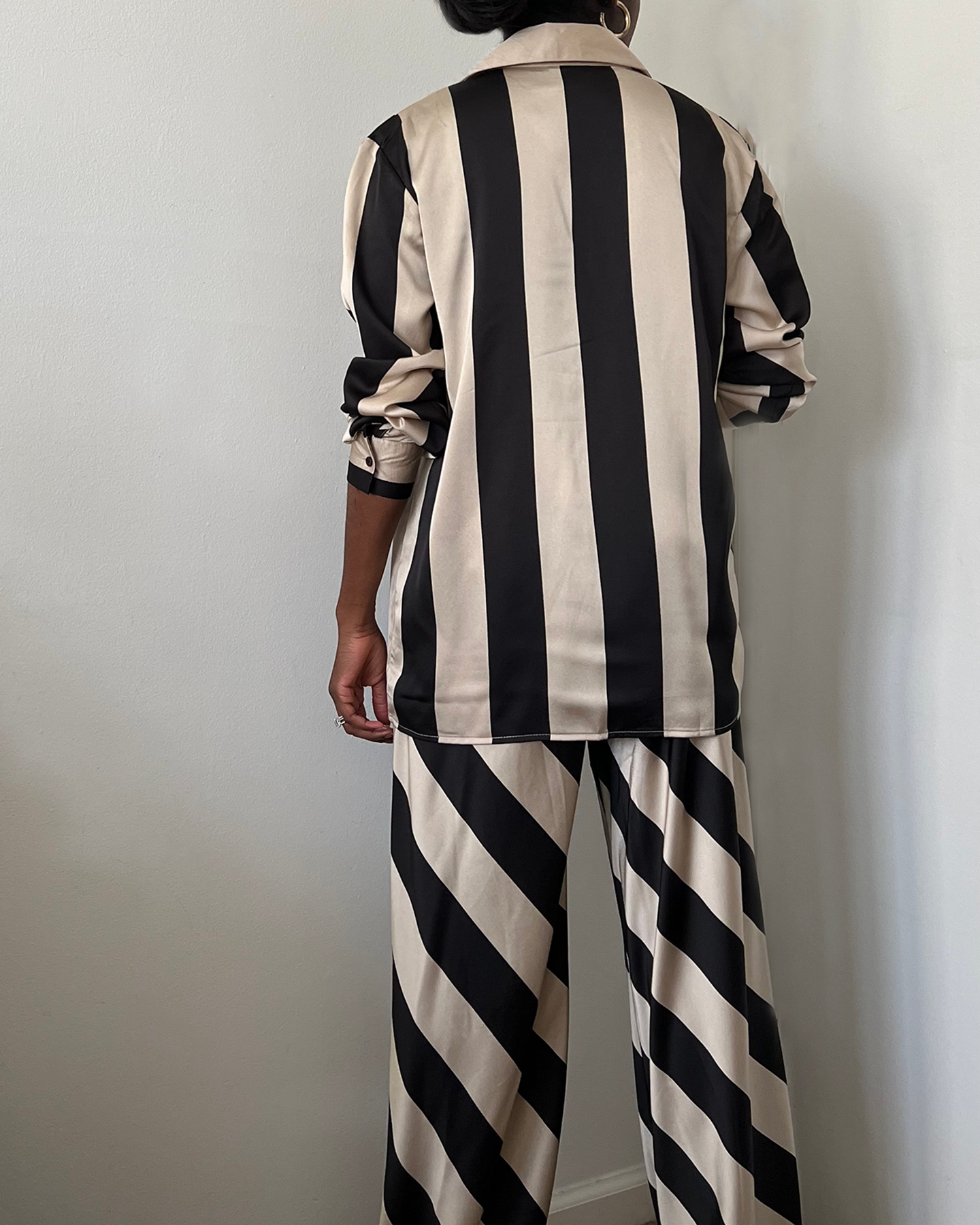 black and tan striped satin wide leg pant set with matching oversized button up shirt