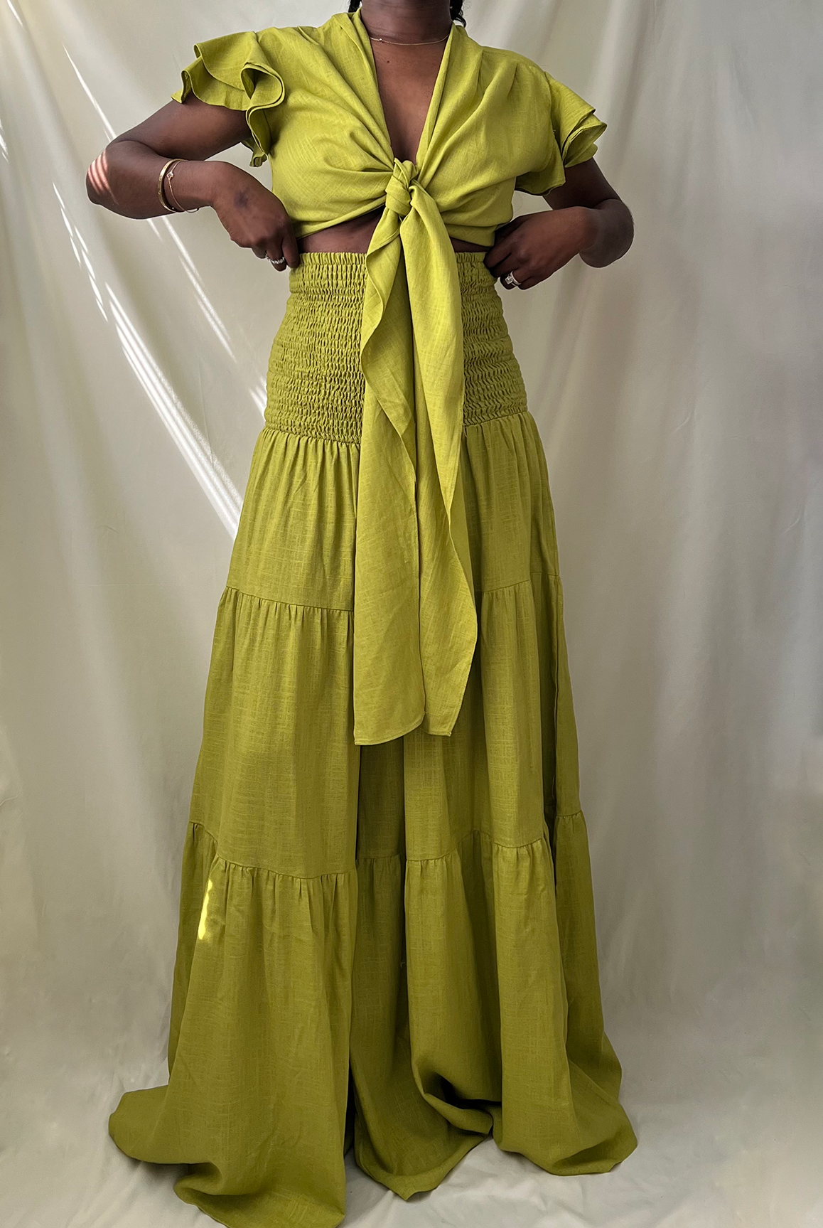green tie front ruffle crop top with smocked tiered high waist wide leg pant set