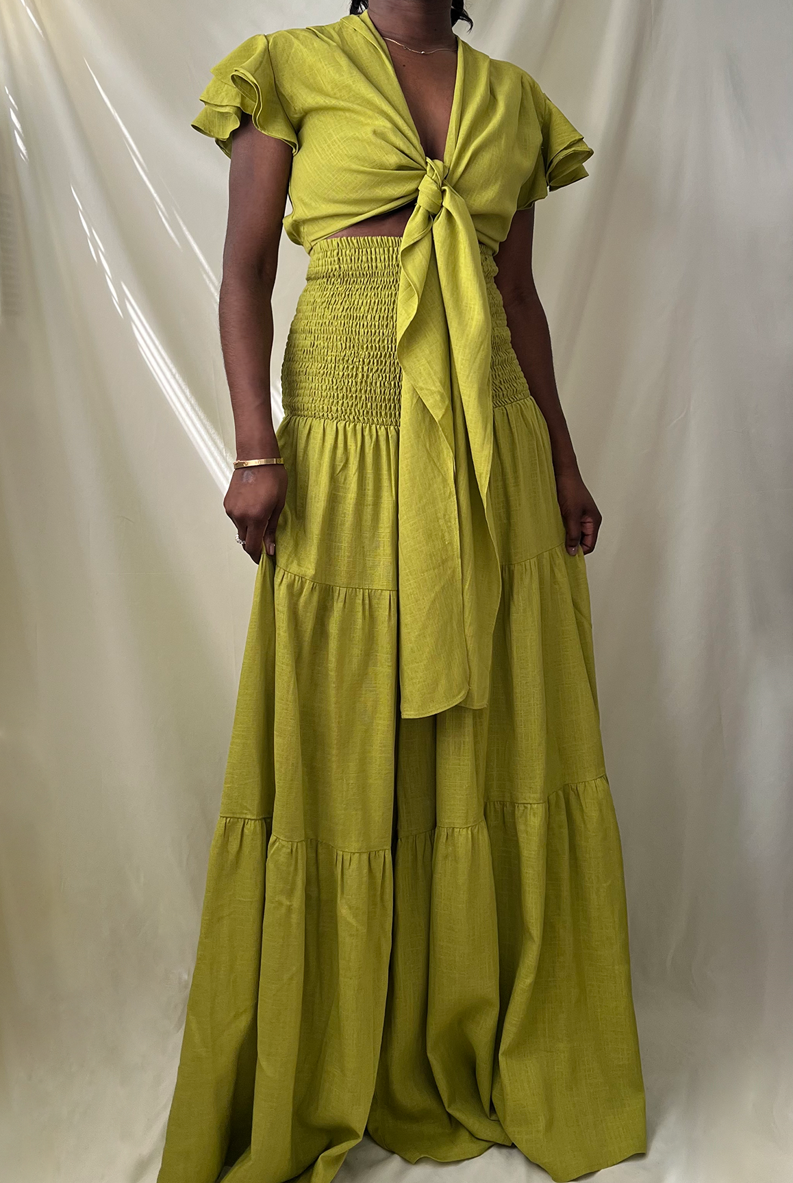 green tie front ruffle crop top with smocked tiered high waist wide leg pant set