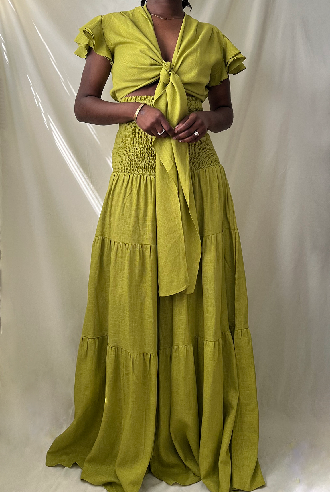 green tie front ruffle crop top with smocked tiered high waist wide leg pant set